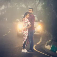 Using car headlights to cut through the fog at Nandi Hills for a pre-wedding shoot. This technique creates a moody, film-like scene that feels both intimate and dramatic.