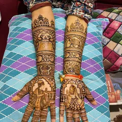 A classic Rajasthani bridal set with matching designs on both arms. The palms feature dulha-dulhan figures, while the arms are decorated with elephants and palace architecture.