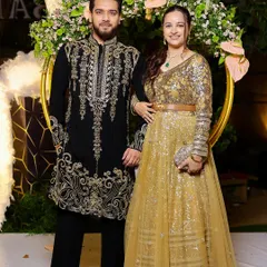 A beautiful couple at a festive event. We had the pleasure of dressing the groom in our black and gold embroidered kurta, which perfectly complements his partner's glittering gown.