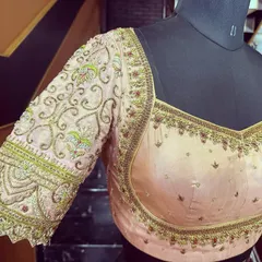 The finished blouse on a mannequin, showcasing the elegant neckline and the intricate embroidery that flows down the sleeves. This piece is ready to be paired with a beautiful Kanjivaram saree.