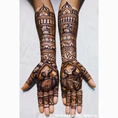 This intricate bridal henna showcases a blend of auspicious symbols. You can see graceful peacocks on the palms and the sacred swastika symbol on the forearms, all woven together with detailed filler patterns.