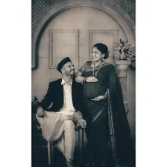 A tender moment of connection between the couple during their traditional studio session. Her hand on his shoulder, their shared gaze speaks volumes about their partnership on this journey to parenthood.