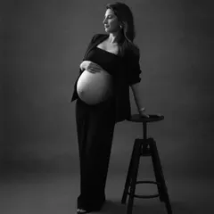 A portrait of quiet confidence. The mom-to-be's pose is strong and graceful, and the blazer adds a touch of modern sophistication to this timeless black and white image.