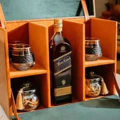 For the connoisseur, we present our luxury whiskey hamper. It features a premium bottle of your choice, crystal glasses, and gourmet nuts, all housed in a sophisticated, handcrafted leatherette box.