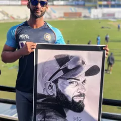 Holding the finished hyper-realistic pencil sketch of Virat Kohli. This is the kind of detailed work you can achieve with the right guidance and practice.