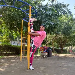 Using a pole at the park for a standing split variation. This is an advanced stretch that deeply opens the hips and hamstrings, and it’s something we can work towards with consistent practice.