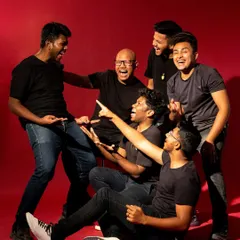 A candid, high-energy shot of the band members laughing and interacting. This image captures their personality and chemistry, adding a relatable and authentic layer to their portfolio.