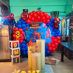 Here is another view of the Spiderman party, showing the custom 'OMI' letter blocks and pedestals for the cake. I ensure every element, from the main backdrop to the small details, fits the chosen theme perfectly.