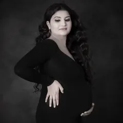 A classic and timeless black and white maternity portrait. This simple, elegant shot focuses on the beautiful silhouette and the mom-to-be's serene expression.