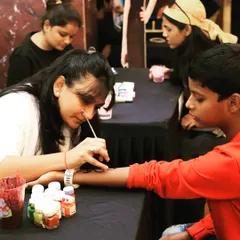 A young guest gets a temporary tattoo from one of our skilled artists. This is a fun and safe activity that we can provide for family-friendly events, birthday parties, and community festivals.