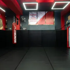 The main training area at our gym, featuring a large matted space and inspirational murals. This is where the daily grind happens.