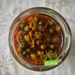 This is a jar of my authentic Rajasthani Kair Pickle. Kair are desert berries that I source directly from Rajasthan during the summer. They are soaked in buttermilk to soften and develop a sour taste before being pickled with grated raw mango and spices. It's a rare flavour that brings the taste of Rajasthan to your plate.