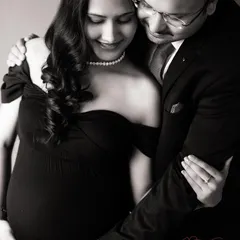 A timeless black and white portrait showing a tender embrace. I guide couples into poses that feel natural, capturing the quiet love and anticipation of parenthood.