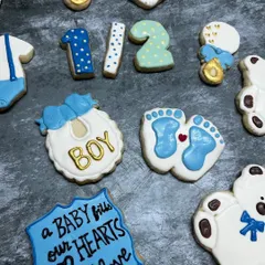 How sweet are these cookies for a baby boy's half-birthday celebration? I can create custom shapes like onesies, bibs, and teddy bears for baby showers and announcements.