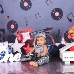 A full view of the music-themed setup, with a baby boy playing a toy keyboard. This dynamic and creative theme is perfect for little ones with a love for music.