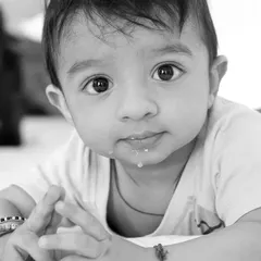 Color is descriptive, but black and white is interpretive. This close-up monochrome portrait of a baby captures the innocence and detail in their expression.