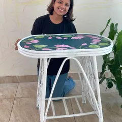 Proudly presenting a refurbished cane table, where I hand-painted a lotus pattern on the top to give it a fresh, botanical feel.