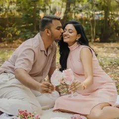 Celebrating the sweet news with an outdoor picnic. These candid moments, like a gentle kiss on the cheek, are the ones you'll look back on and smile. It’s a beautiful way to announce you're expecting a girl.