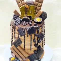 A tall Belgium chocolate cake for a true chocolate lover. This design is an overload of deliciousness, topped with various chocolate bars, cookies, and a rich drip.