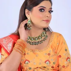 A full view of the party makeup, showing how it pairs with the client's embroidered yellow blouse and traditional jewelry. This look is perfect for a sangeet or festive party.