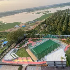 An aerial view of our completed work at Vaishnavi Tech Square, showing the integration of recreational facilities within the master plan. We designed a multi-sport court and an amphitheater overlooking the natural landscape, creating active zones for the community.