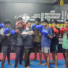A group of my boxers, Team Panthers, posing together after a tough training session. There is a strong bond of camaraderie and respect among my students.