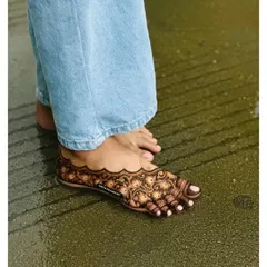 A clear, still shot of our intricate foot mehandi design. The pattern is dense and symmetrical, creating a beautiful adornment that resembles a traditional payal.