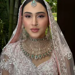 A portrait capturing her serene beauty. The airbrush makeup ensures a flawless, long-lasting finish, which is essential for an outdoor wedding.