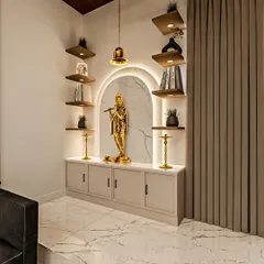 A beautiful and modern pooja room idea. This design features a golden Krishna statue in a backlit arch, surrounded by floating shelves for other deities and sacred books.