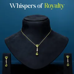 Whispers of royalty. This dainty necklace and earring set, featuring vibrant green peridot and a delicate drop of diamonds, carries the grace of a bygone era. It is not about grandeur, it is about a refined grace that lingers.