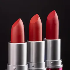 A classic lineup of three Huda Girl lipsticks against a dark background. This type of shot is perfect for showing a range of shades while maintaining a premium feel.