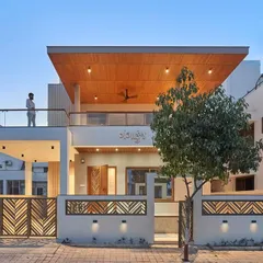 A perfect example of my design-build philosophy. The combination of a cantilevered balcony with a wooden ceiling, glass railings, and custom laser-cut gate panels creates a layered and sophisticated modern exterior.
