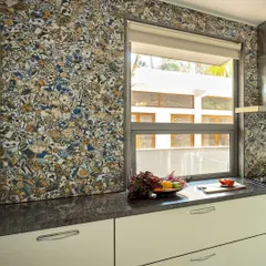 The backsplash in this kitchen is a unique, custom-designed tile mosaic that adds a burst of personality and artistic flair. It transforms a functional wall into a captivating focal point, showcasing our love for bespoke details.