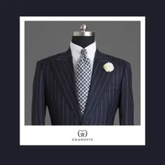 A close-up of the navy pinstripe suit, showcasing the contrast of a gingham tie against the linear pattern of the suit, a bold and stylish choice.