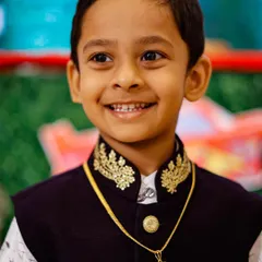 A close-up portrait of a young boy's happy smile at his birthday party. I make sure to capture the genuine joy of children during their special celebrations.