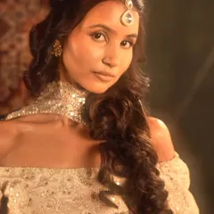 This shot highlights the high-fashion choker and the defined, sculpted makeup look.
