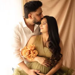 An intimate moment between partners. A gentle kiss on the forehead speaks volumes, capturing the love and support that surrounds this new chapter.