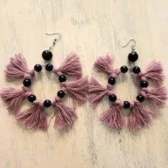A different take on macrame hoops, this pair features dusty pink tassels and black beads. The contrast between the soft fiber and the smooth beads creates a really interesting texture and look.