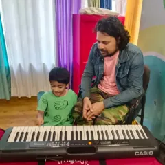 A moment of curiosity between teacher and student. I love it when kids are eager to explore the piano, and I am always ready to answer their questions and encourage them to play.