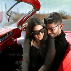 A happy, relaxed moment between the couple in the front seat of the classic car. This pre-wedding photo feels natural and unposed, focusing on their genuine smiles.