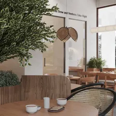 A close-up of the custom seating, where we used a combination of wood and cane weaving. The large indoor plants are housed in custom wooden planters that double as subtle space dividers.