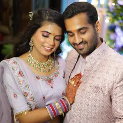 A beautiful couple during their engagement ceremony. For the bride, I created a soft glam look with shimmery lavender eyeshadow and a natural lip color to perfectly match her pastel lehenga, ensuring she looked radiant throughout the event.