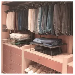 A well-organized closet starts with smart systems. Here, we've used hanging organizers for trousers and stackable shelves for folded items to maximize vertical space and keep everything visible.