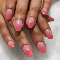 The perfect ombre effect. This design shows a seamless blend from a sheer nude base to a soft pink tip on short, oval nails. It's a timeless and sophisticated choice.