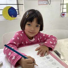 Here, a student practices line work and patterns using a pencil, an essential exercise for developing fine motor control and attention to detail. Our curriculum includes structured activities that build fundamental drawing skills.