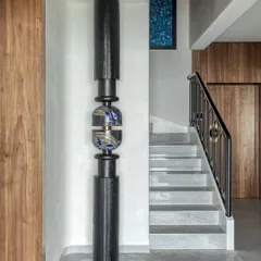 A detail from our "Nostalgia by the Sea" project, showcasing a sculptural art piece that intertwines with the staircase. The design is a love letter to tradition, evoking cherished memories while embracing contemporary comforts.