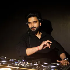 In the zone. A shot of me focused on the mixer, ensuring every transition is seamless and the energy on the dance floor never stops.