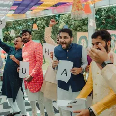 The groom's side having fun with games during the carnival. Capturing the competitive spirit and laughter of these activities is part of documenting the whole wedding experience.