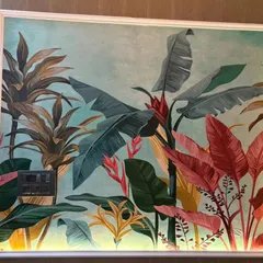 A close-up of a vibrant, hand-painted style tropical mural. I focus on using rich colors and bold leaf patterns to create a piece of art that feels alive and brings a burst of energy to the wall.