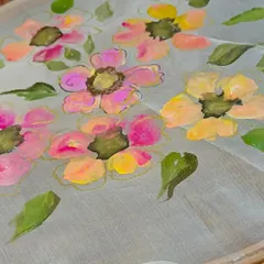 A work-in-progress shot of floral fabric painting, demonstrating how to apply colors to create soft, blended petals.
